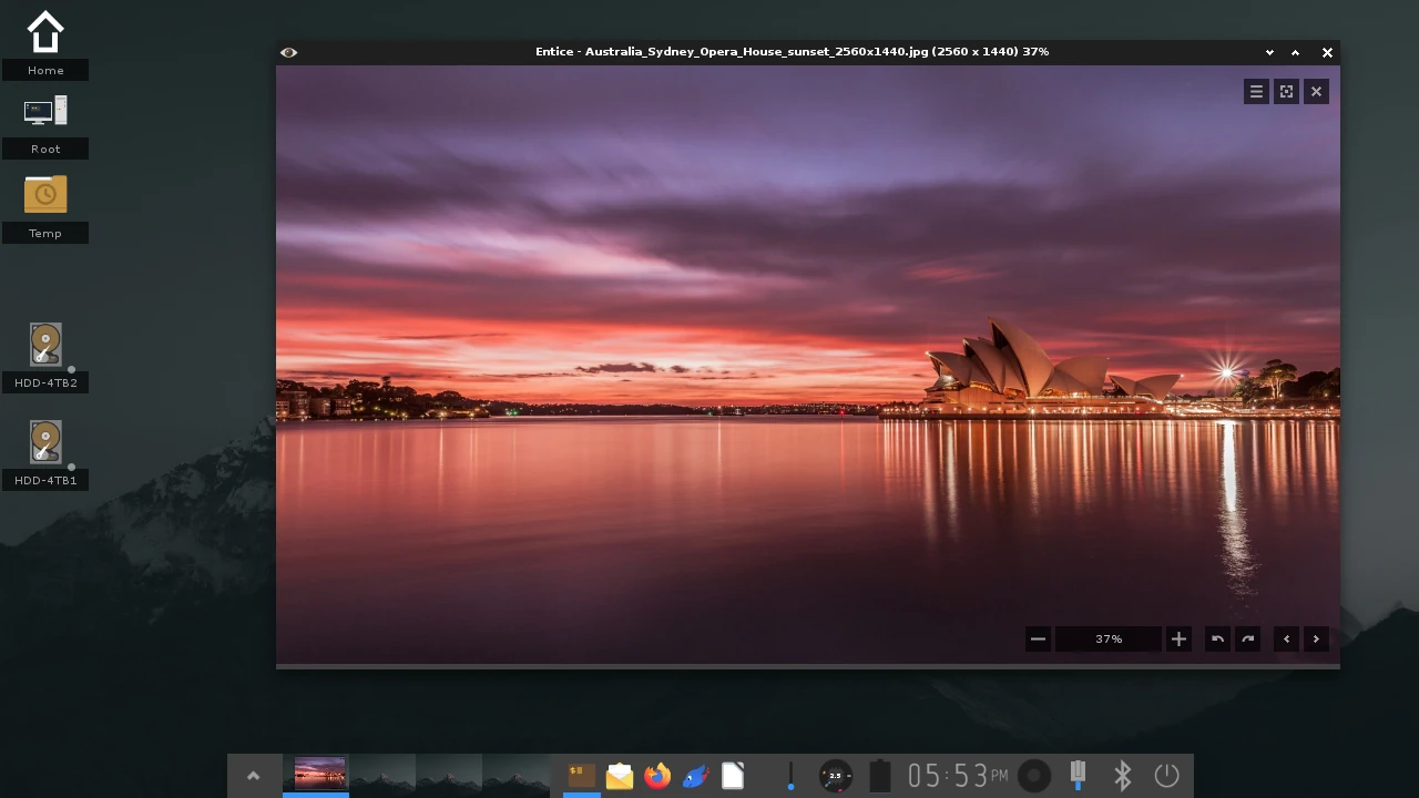 Enlightenment desktop with the Entice image viewer showing a sunset photo above the shelf