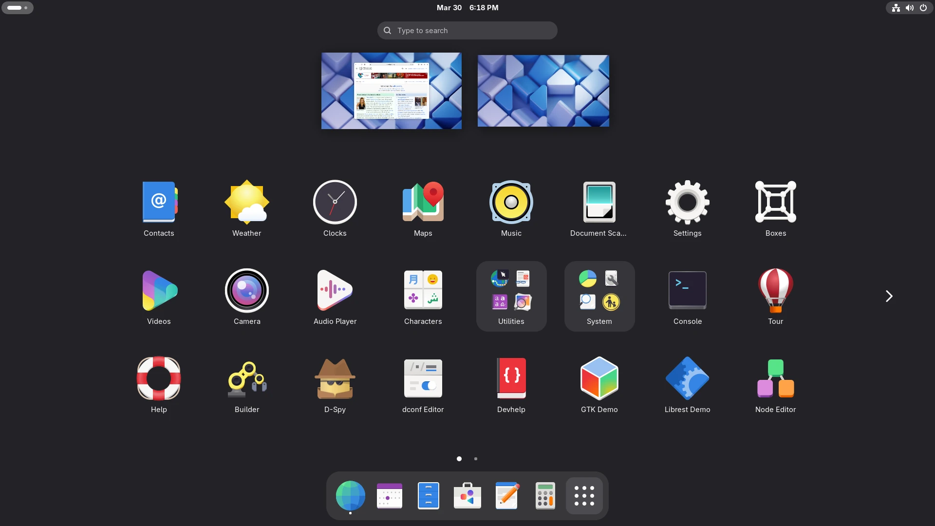 GNOME 48 Activities overview with the application grid, two workspaces and the dock