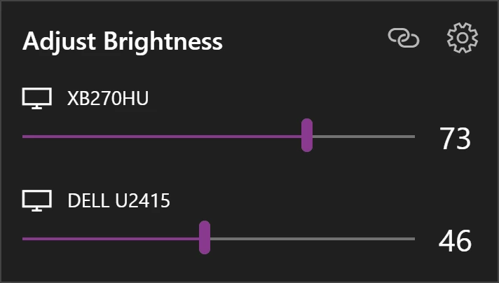 Brightness flyout with sliders for two monitors and an Adjust Brightness heading
